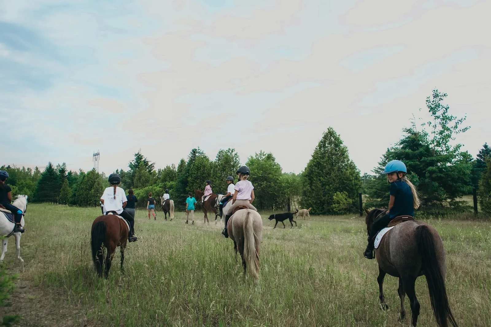 Counsellors leading a group ride through the field