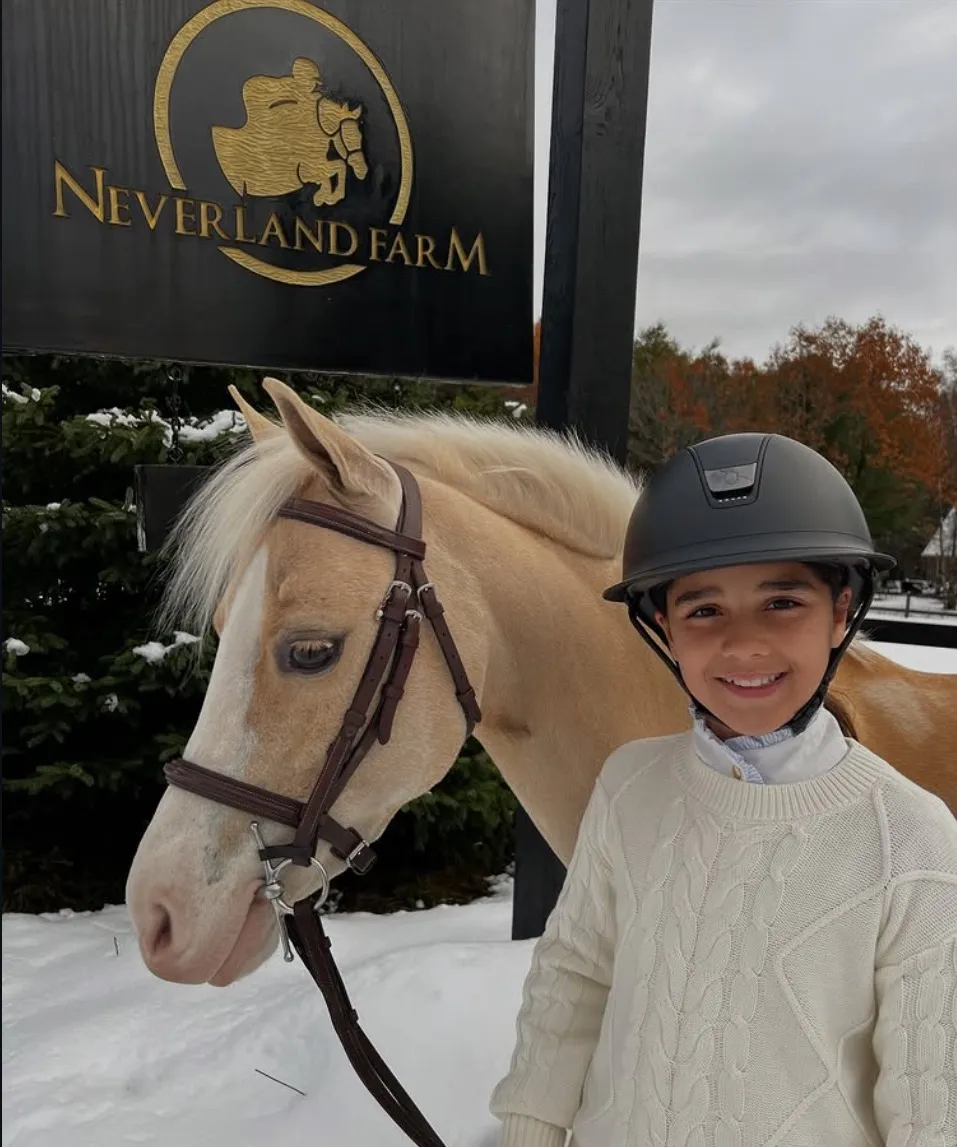 Neverland athlete with her pony at the farm
