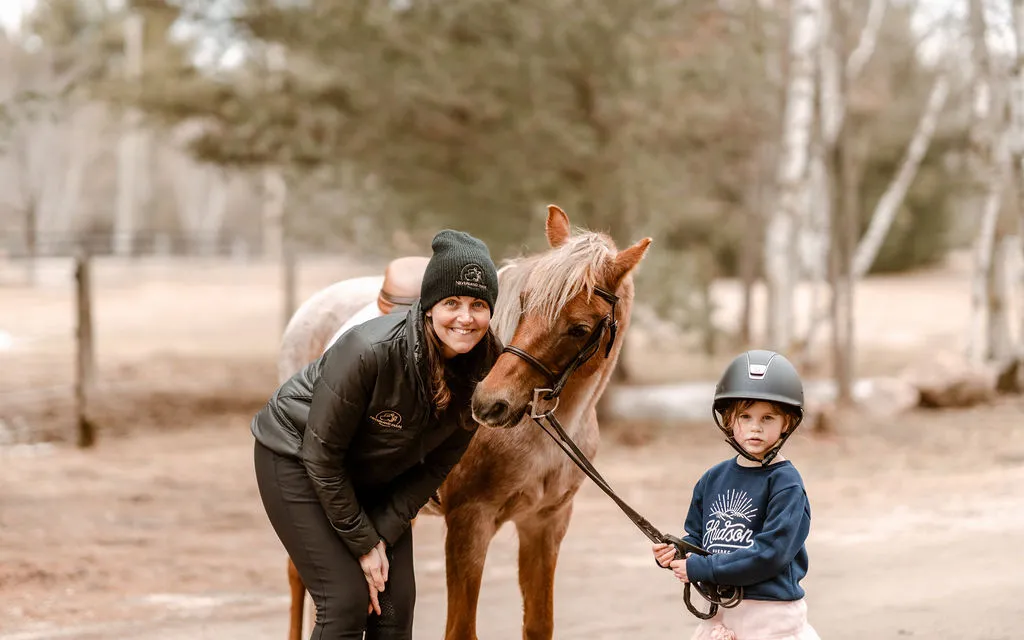Young rider and coach with a pony at Neverland