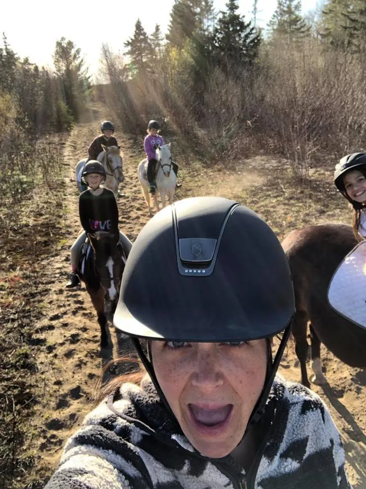 Kelly Tellier on a trail ride with kids and ponies